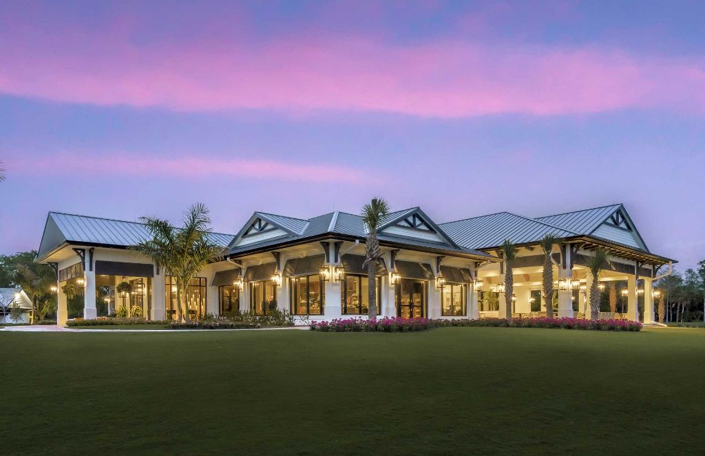Florida residential building at dusk with metal roof and palm trees